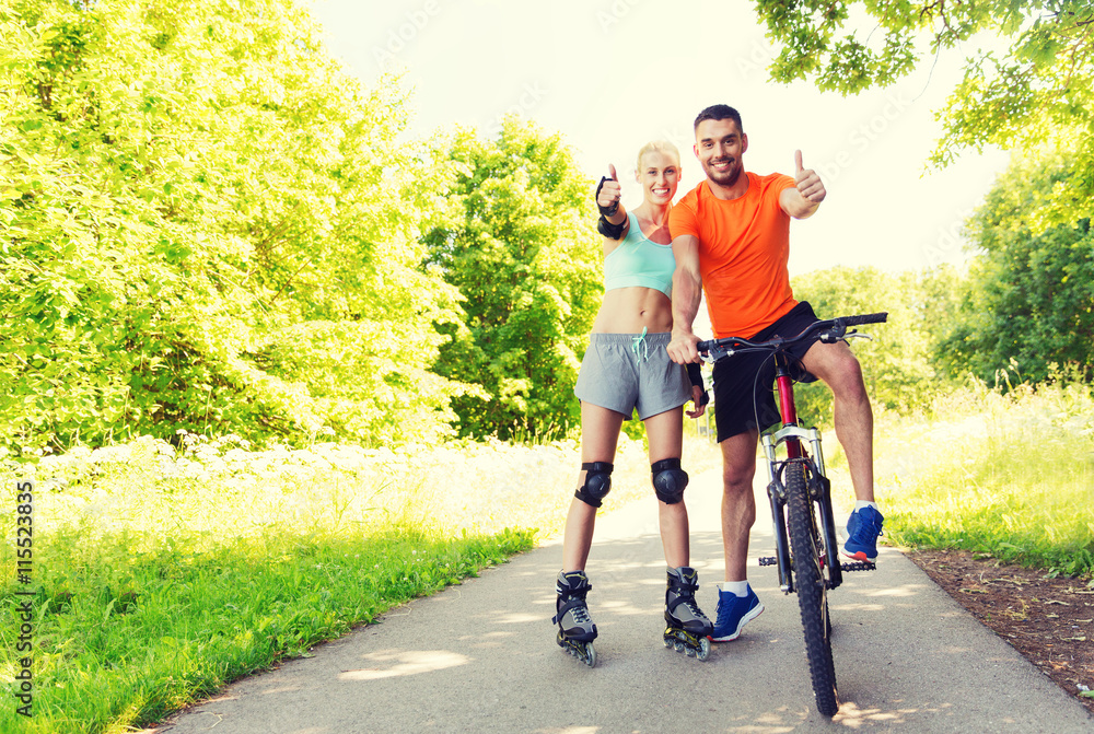 couple on rollerblades and bike showing thumbs up Stock Photo Adobe Stock