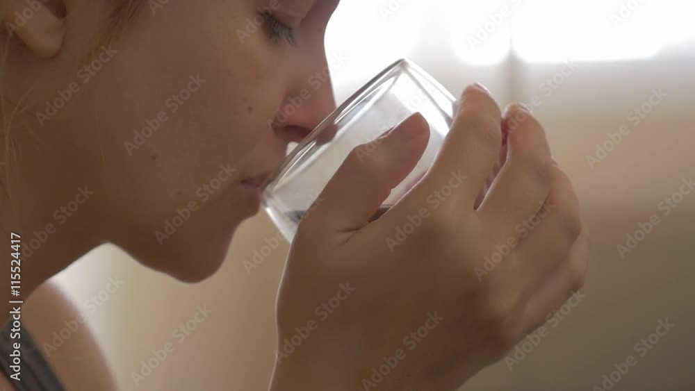 Woman holding hot cup in hands and drinks tea 1080p HD video - Drinking tea from glass cup slow motion 1920X1080 FullHD footage Woman holding hot cup in hands and drinks tea 1080p HD video - Drinking tea from glass cup slow motion 1920X1080 FullHD footage