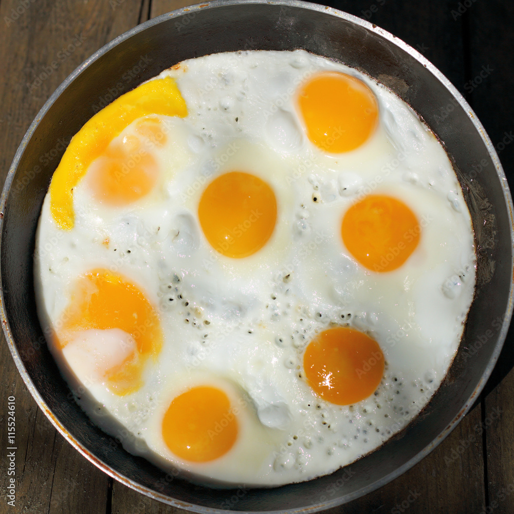 hot appetizing dish/ flat lay, fried eggs in a frying pan top view hot appetizing dish/ flat lay, fried eggs in a frying pan top view