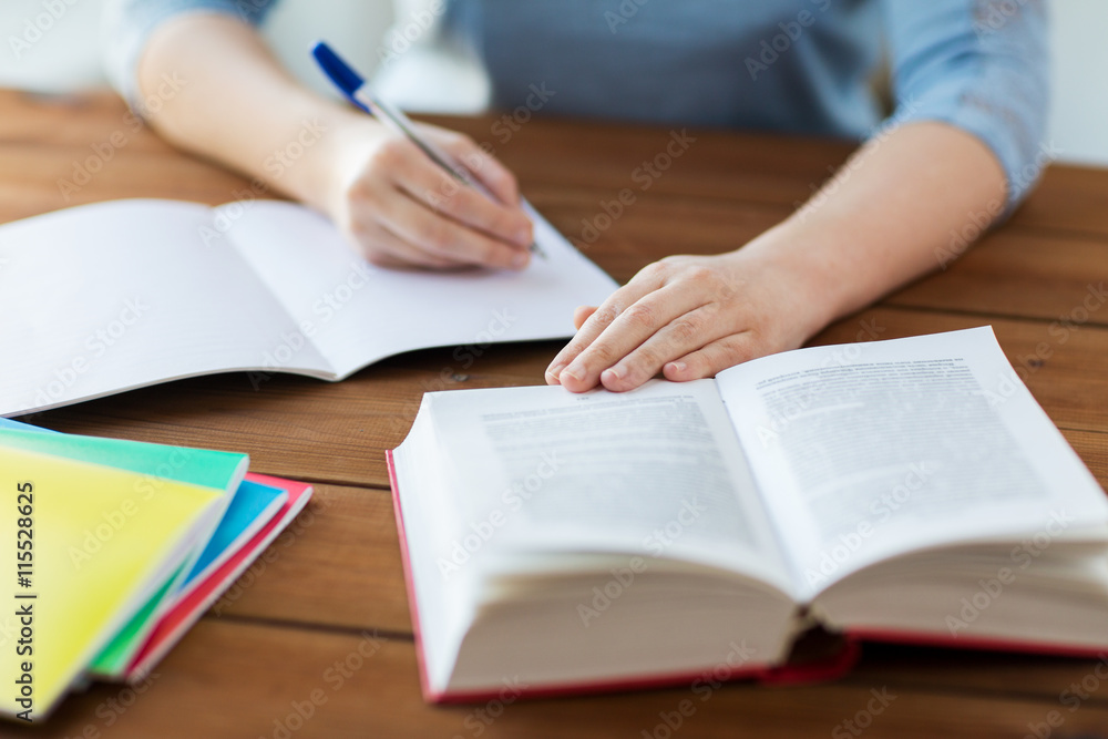 close up of student with book and notebook at home close up of student with book and notebook at home