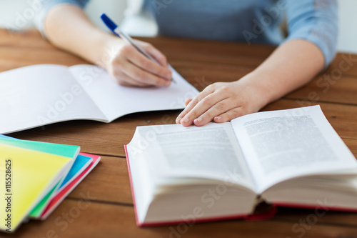 Obraz na plátně close up of student with book and notebook at home