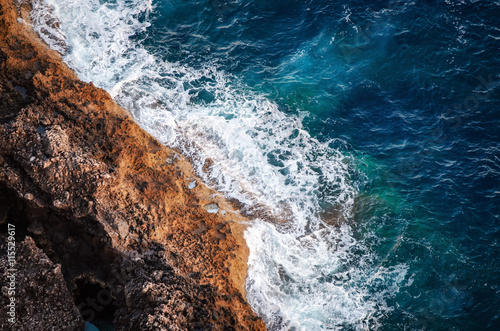 Waves breaking on the shore rocks with sea foam, Mallorca, Spain