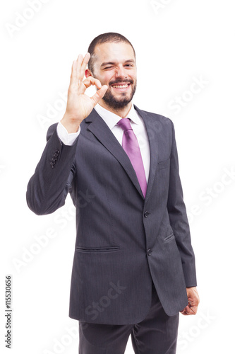 Young business man showing Ok sign, isolated on white background