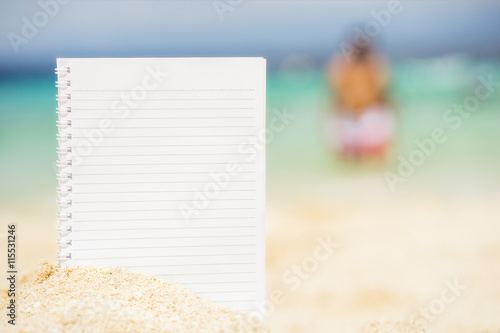 empty notepad on the background of tropical sea at sunny day