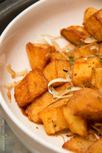  Potato Wedges with Rosemary and Herbs in white Bowl closeup