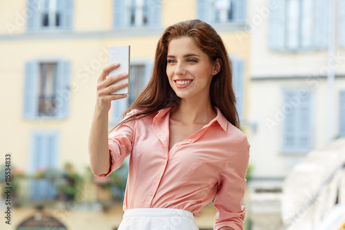 Beautiful woman photographing selfie on a tabl Free Download Beautiful woman photographing selfie on a tabl - GFXLoad