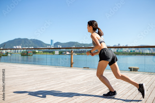 Woman running at seaside walk © leungchopan