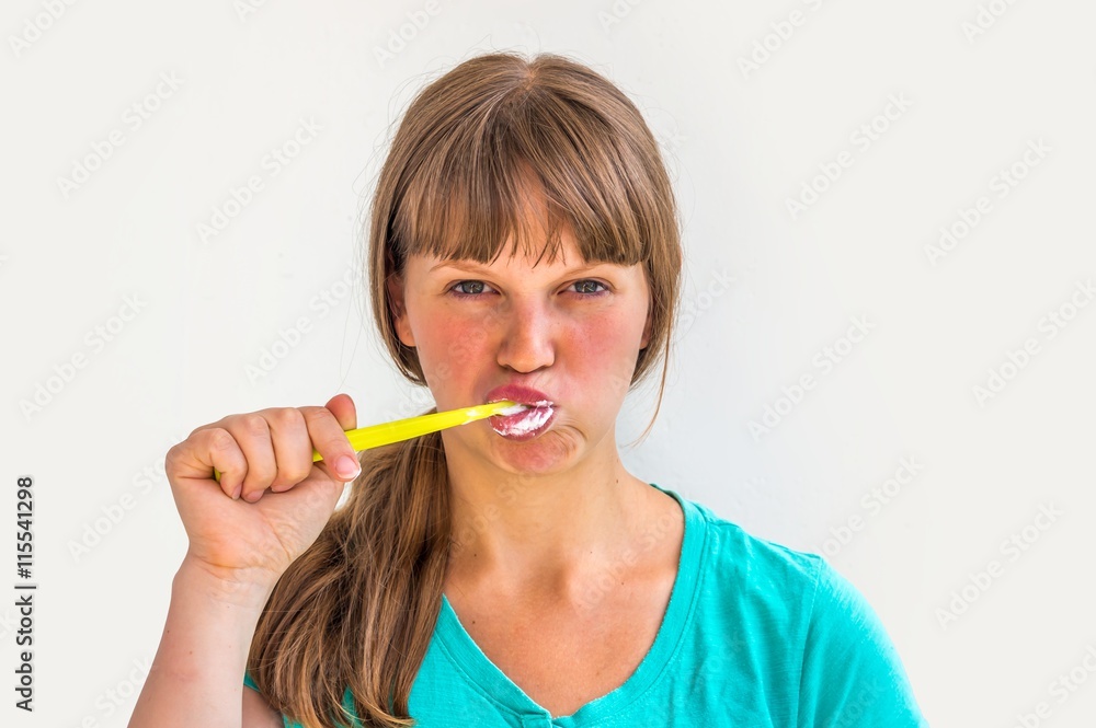 Young lady brushing teeth in the morning Young lady brushing teeth in the morning