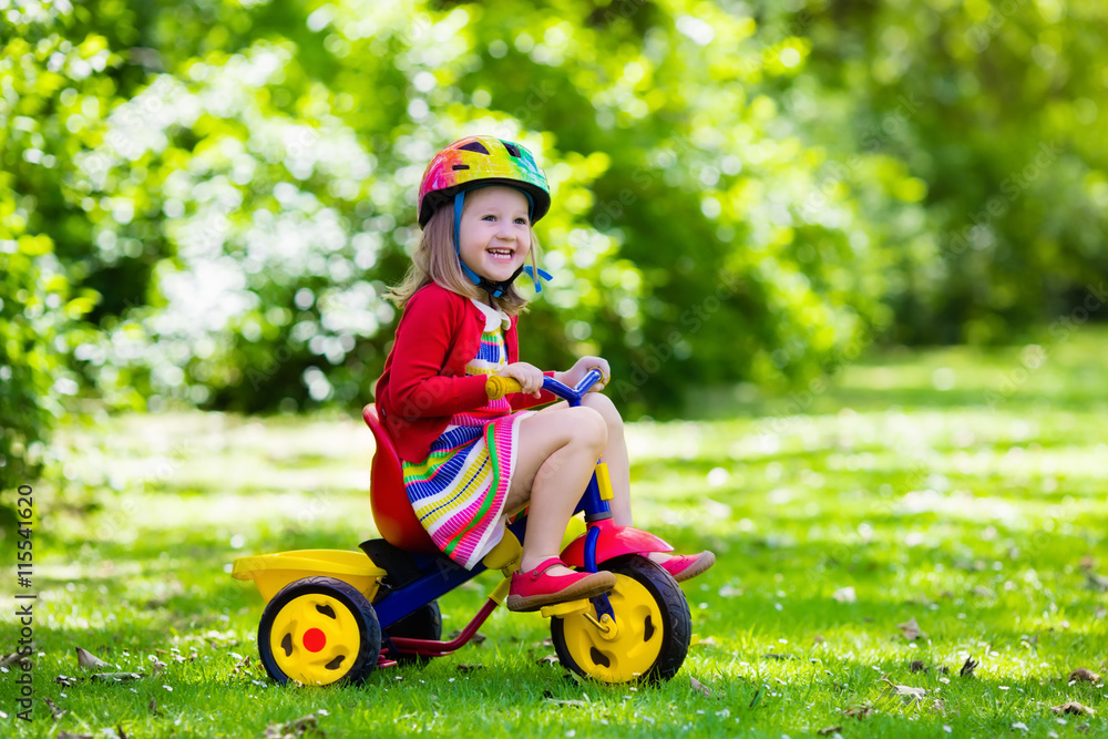 Little girl riding a tricycle Stock Photo Adobe Stock