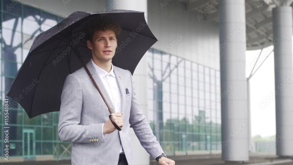 custom made wallpaper toronto digitalYoung successful businessman looking at watch, waiting for taxi, business centre background.