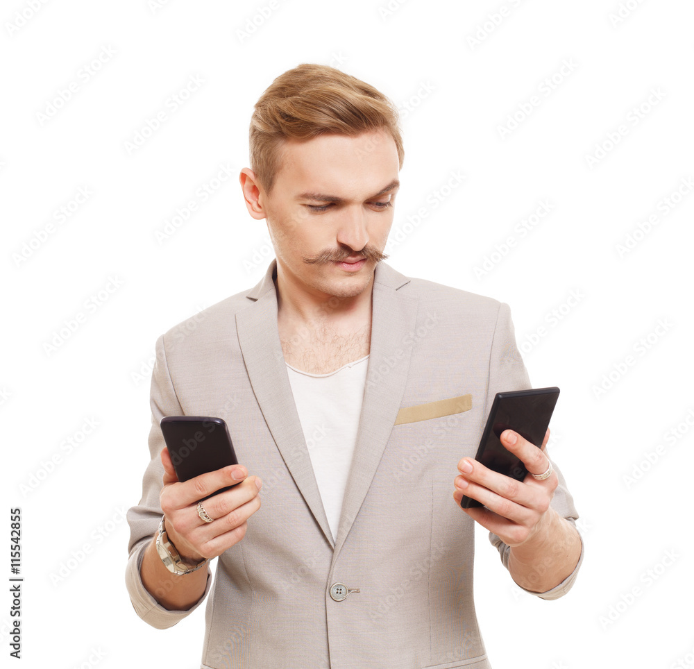 Foto Stock Young man holding two mobile phones, make choice | Adobe Stock