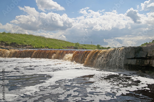 Summer landscape with waterfall in Leningrad Region. Russia