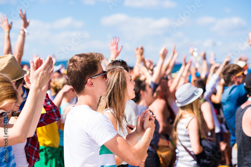 Teenagers at summer music festival having good time