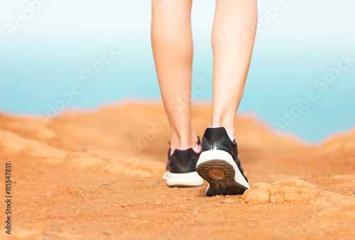 Woman walking on a path. (Fitness concept)