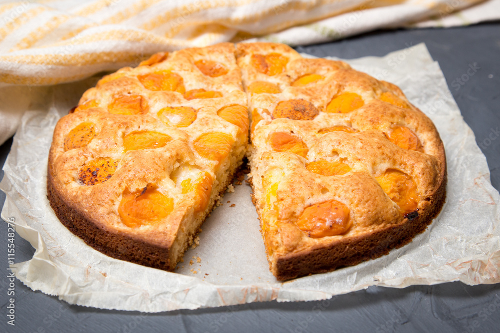 apricot pie on the baking paper with ripe apricots