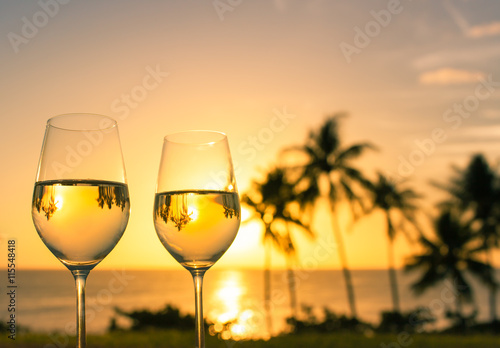 Vacation and holiday concept. Enjoy a glass of wine and beautiful sunset view. 
