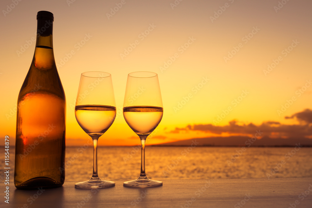 Pair of wine glasses against a beautiful sunset. 