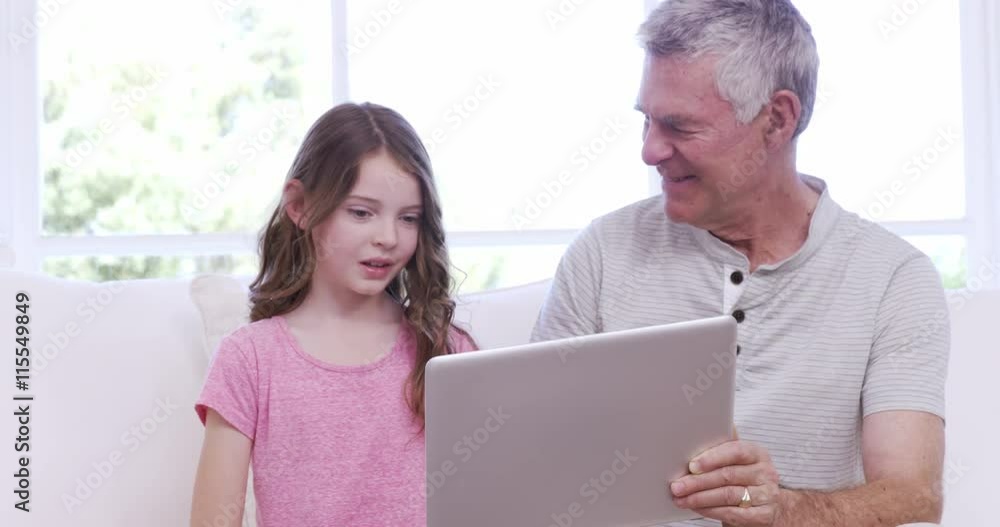 Grandfather and granddaughter using tablet Grandfather and granddaughter using tablet