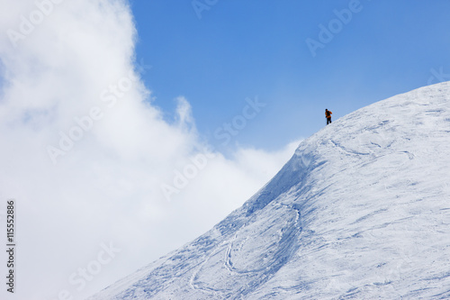 France, Val Thorens, Meribel, Skier on top of snowy hill photo