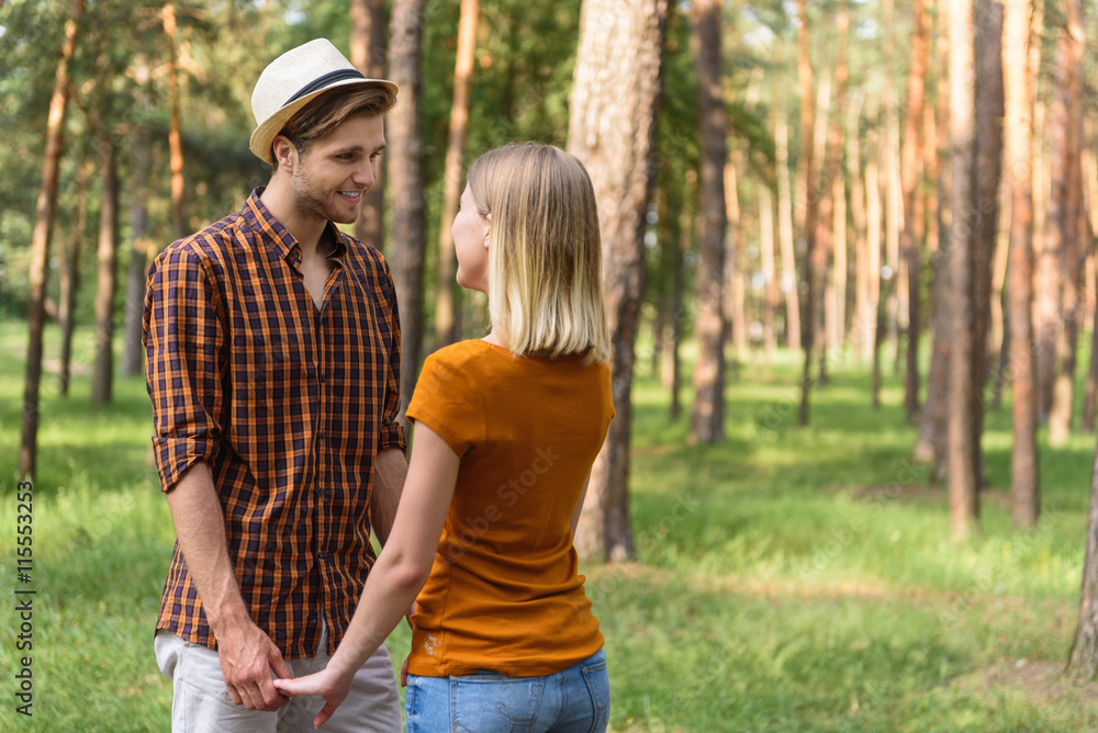 Happy guy and girl resting in forest Happy guy and girl resting in forest