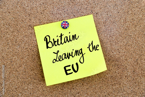 Yellow paper note pinned with Great Britain flag thumbtack and text BRITAIN LEAVING THE EU