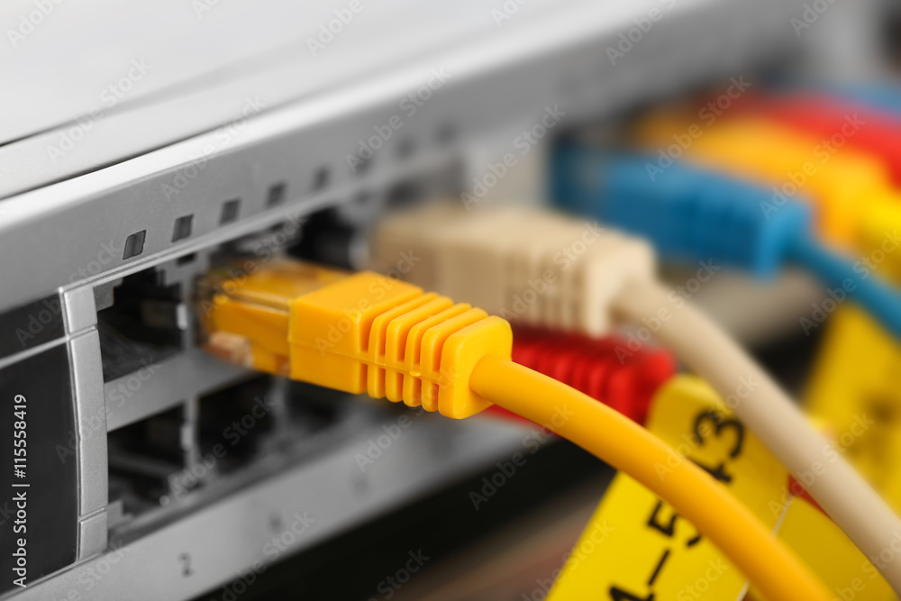 Ethernet cables connected to network switch, close up Ethernet cables connected to network switch, close up