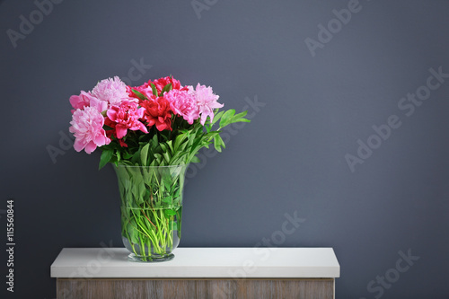Beautiful peony bouquet on dark wall background