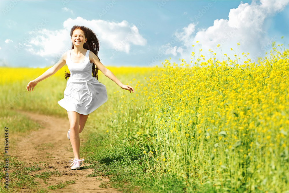 Sweet girl in meadow with wild spring flowers Sweet girl in meadow with wild spring flowers