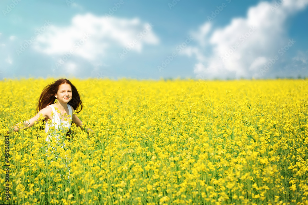 Sweet girl in meadow with wild spring flowers Sweet girl in meadow with wild spring flowers