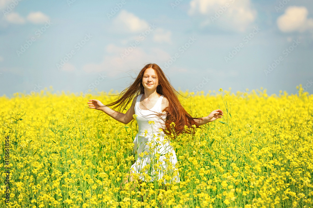 Sweet girl in meadow with wild spring flowers Sweet girl in meadow with wild spring flowers