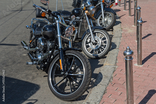 Classic motorcycles parked on a city street. Transport