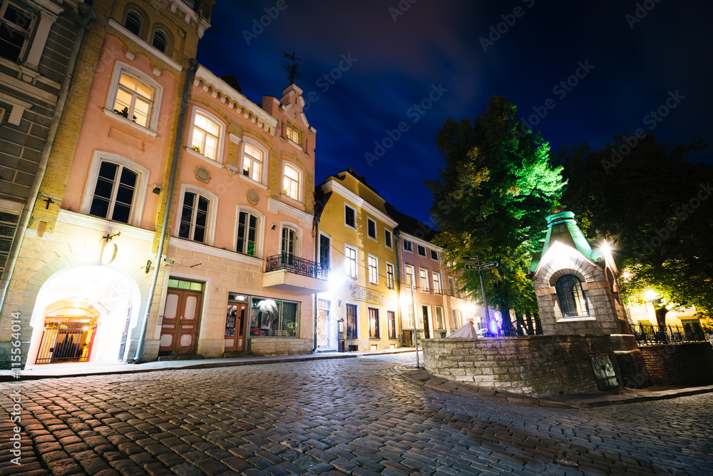 Cobblestone street and medieval architecture at night, in the Ol