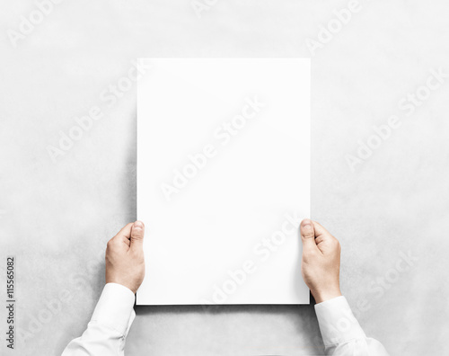 Hand holding white blank poster mockup, isolated. Arm in shirt hold clear broadsheet template mock up. Affiche bill surface design. Broadside pure print display show. Sticking a3 poster on the wall.