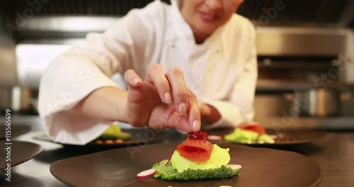 Smiling chef finalizing dishes in the kitchen