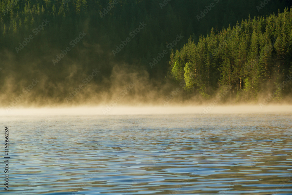 Sunrise over foggy lake Sunrise over foggy lake