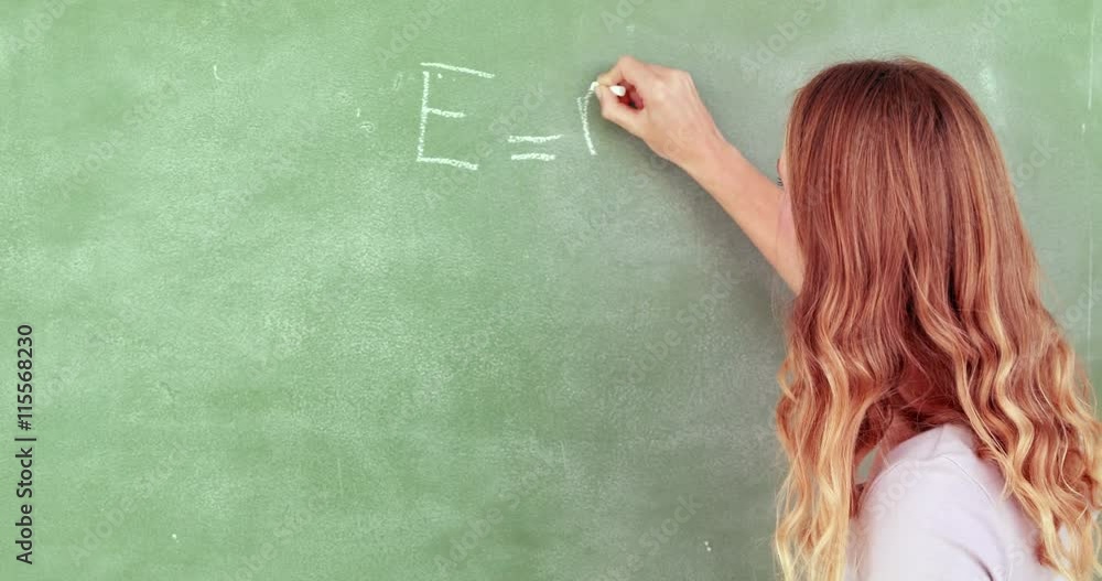 Teacher writing e = mc squared in high quality 4k format Teacher writing e = mc squared in high quality 4k format