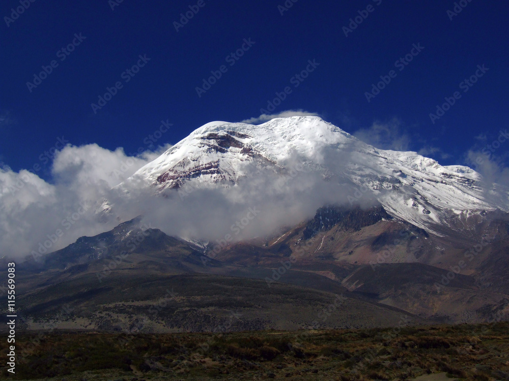 Ecuador´s highest peak, glacieted Mt. Chimborazo, with clear blue sky and clouds