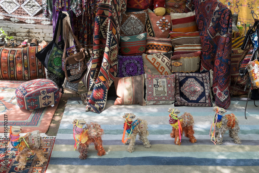 Fototapeta premium Colorful display of ethnic crafts, rugs and pillows made of tribal weavings