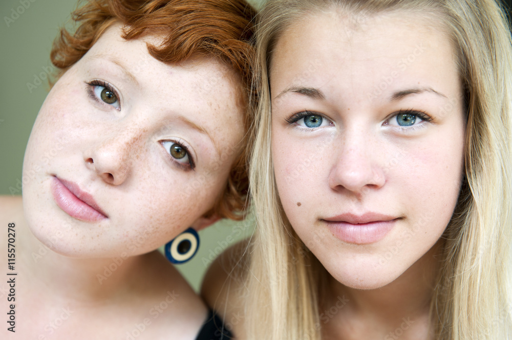 Portrait of redhair young woman and blonde teenage girl (16-17) Portrait of redhair young woman and blonde teenage girl (16-17)