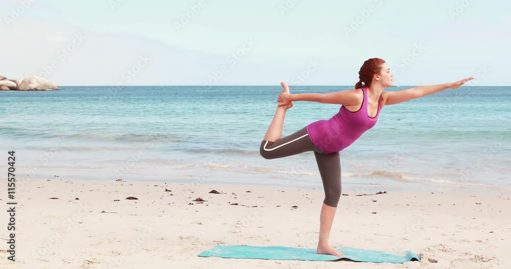 Woman doing yoga on the beach Woman doing yoga on the beach
