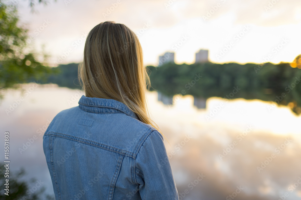 Sweden, Stockholm, Liljeholmen, Teenage girl (16-17) standing at edge of lake Sweden, Stockholm, Liljeholmen, Teenage girl (16-17) standing at edge of lake