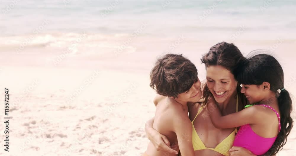 Cute family hugging on the beach in slow motion Cute family hugging on the beach in slow motion