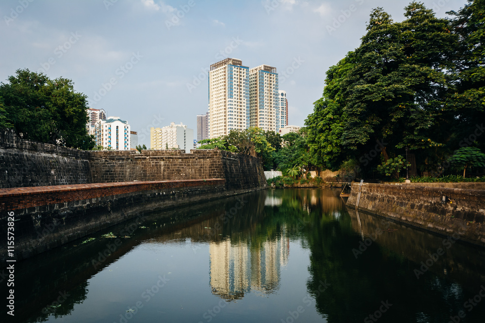 Modern building reflecting in the moat at Fort Santiago, in Intr