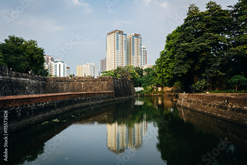 Modern building reflecting in the moat at Fort Santiago, in Intr