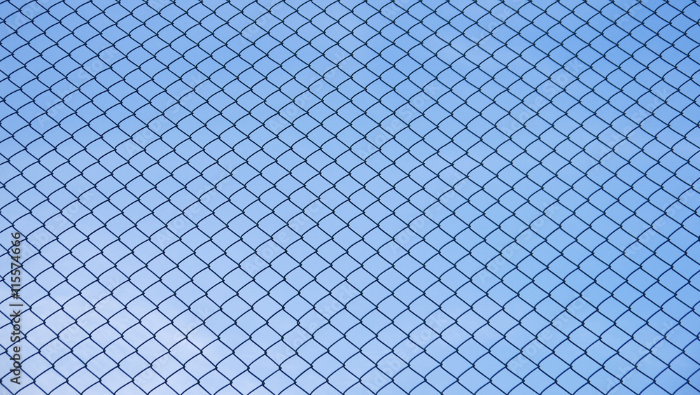 Green seamless fence chain, Iron wire fence on blue sky background Green seamless fence chain, Iron wire fence on blue sky background