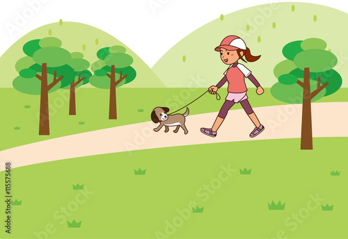 広場で犬の散歩をしながらウォーキングをする女性