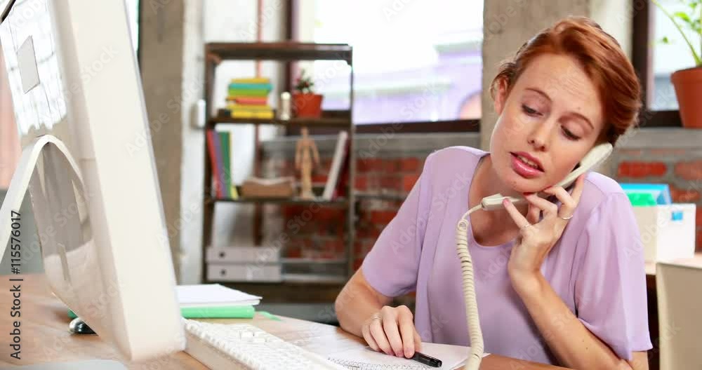 Casual businesswoman on the phone at her desk in high quality 4k format Casual businesswoman on the phone at her desk in high quality 4k format