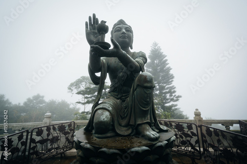Statue at the Tian Tan Buddha (The Big Buddha) in fog, at Ngong