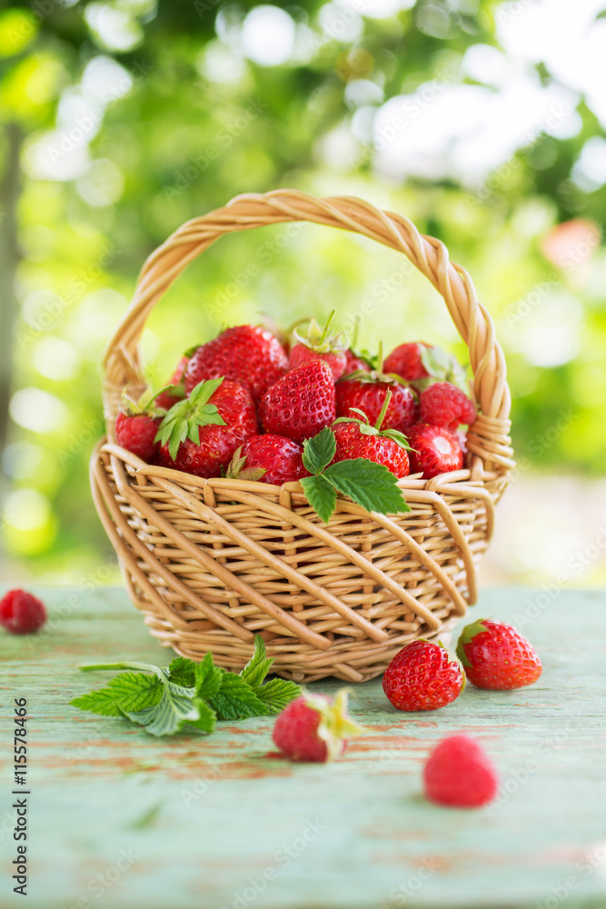 Ripe strawberries with leaves in a basket Ripe strawberries with leaves in a basket