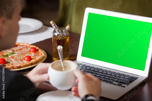 Wallpaper Mural Business, technology. Young man working on a laptop with a mug o Torontodigital.ca
